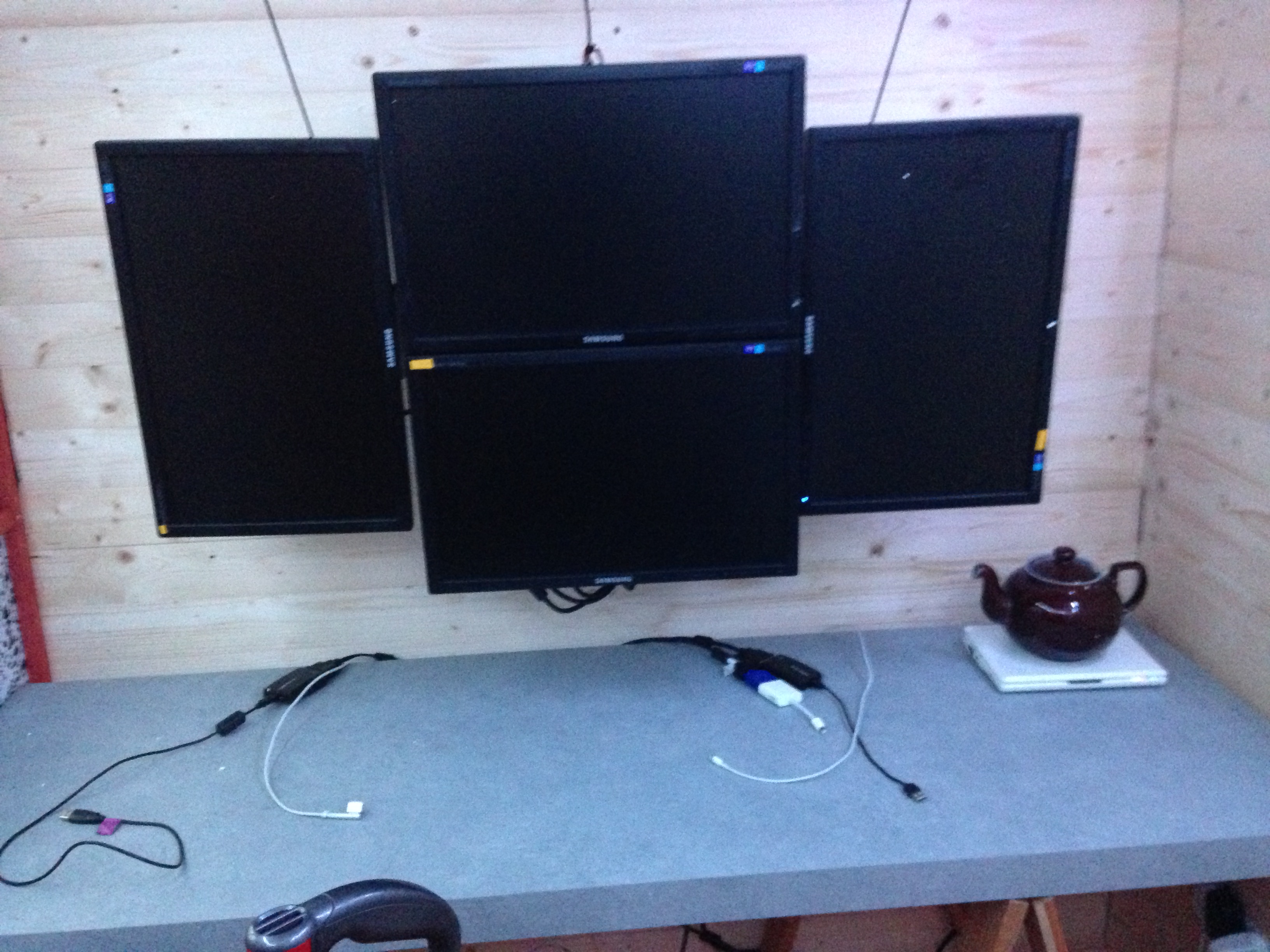 My monitors hanging in front of a fully cladded wall with the cables tidied away