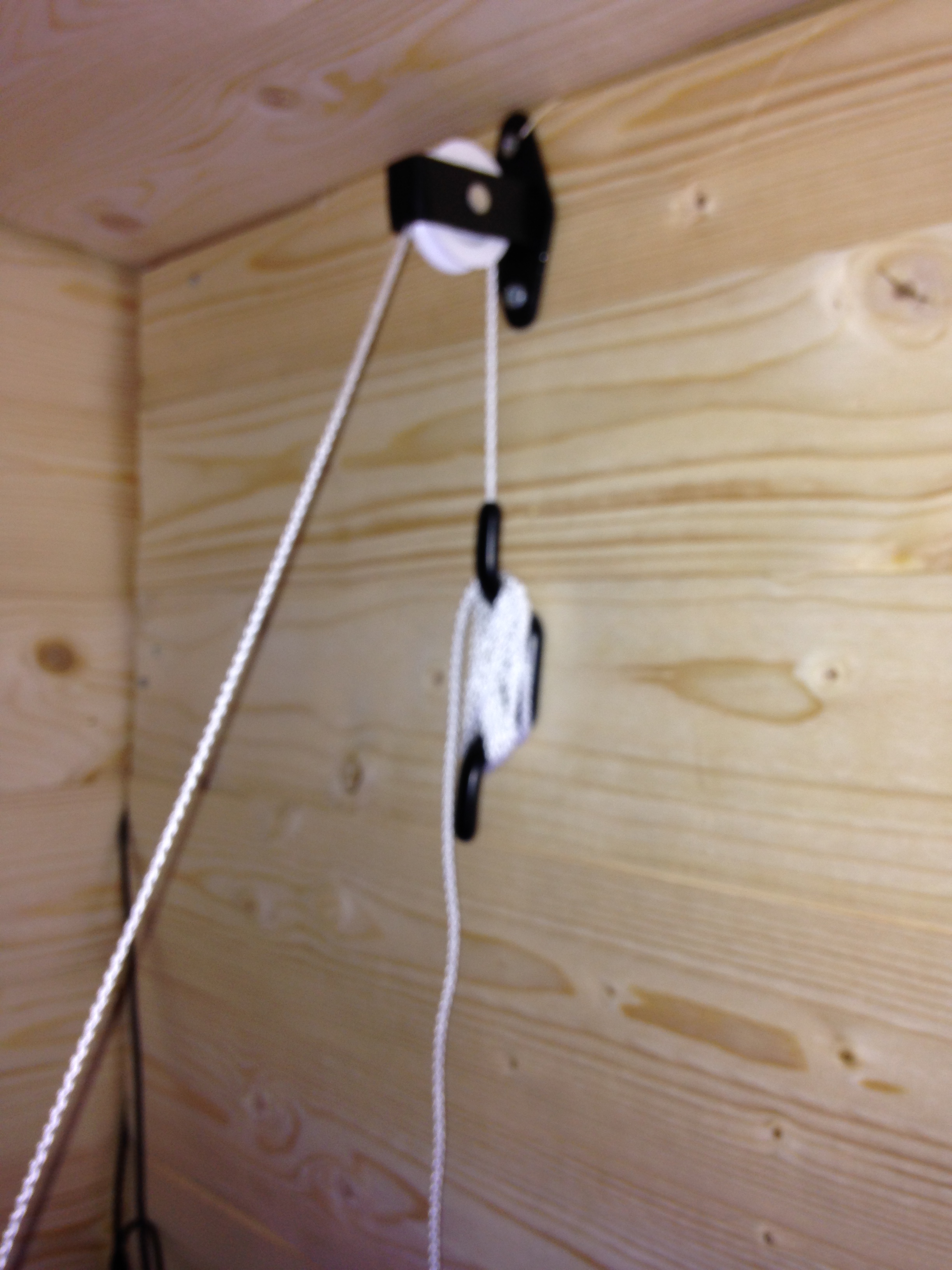 Close up of white cord around the pulleys